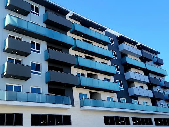 A modern building with balconies and windows.
