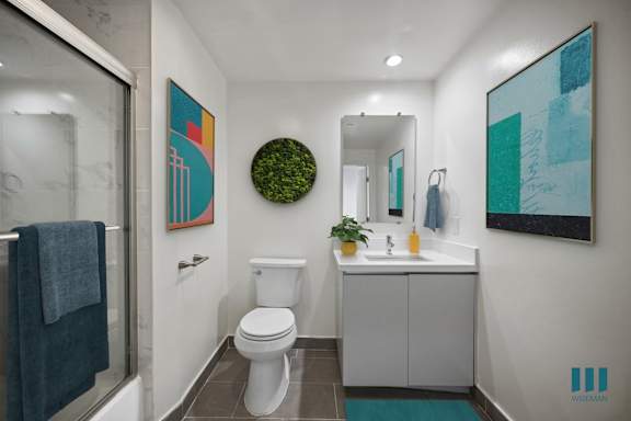 A bathroom with a white toilet and a white sink.