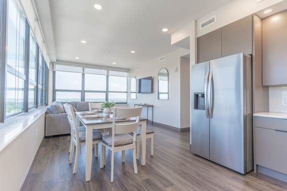 A modern kitchen with a dining table and chairs.