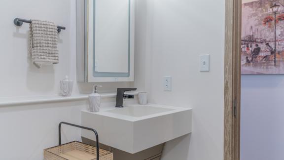 A white bathroom sink with a mirror above it.