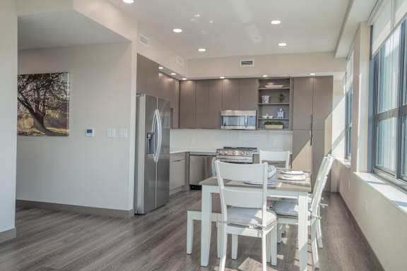 A modern kitchen with a dining table and chairs.