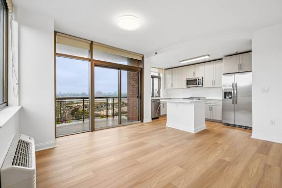 A modern kitchen with a view of the beach.
