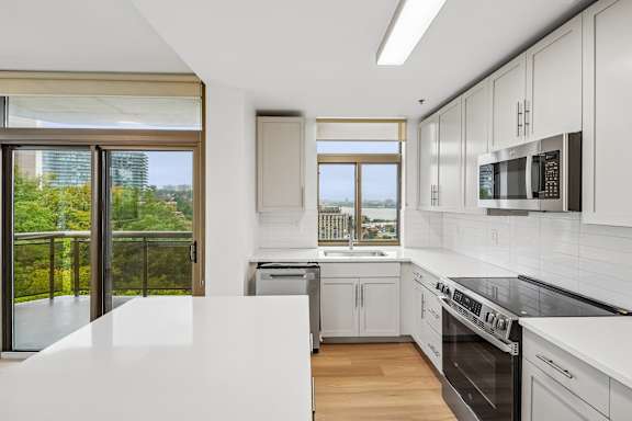A modern kitchen with a view of the city.