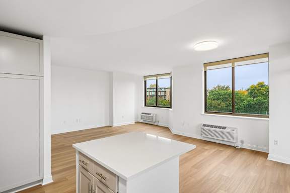 A white kitchen with a large island in the middle.
