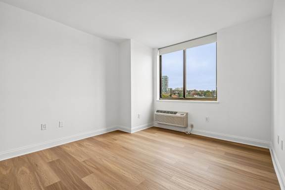 A room with a window and a heater.