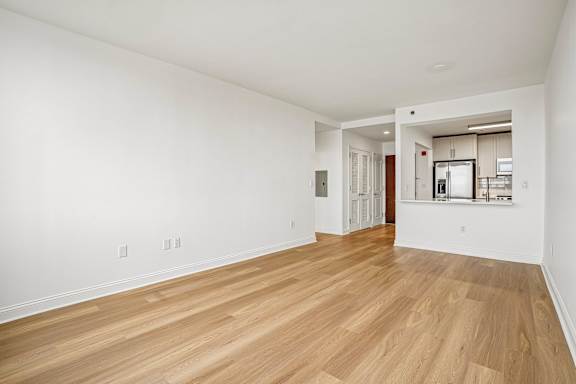 A room with wooden floors and white walls.