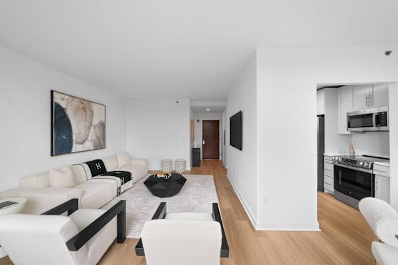 A modern living room with a white couch and a black coffee table.