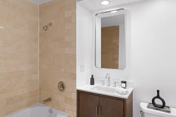 A bathroom with a white sink and a white bathtub.