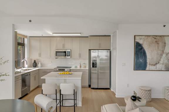 A modern kitchen with a dining table and chairs.