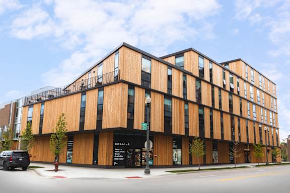 A modern building with a black and wood exterior.