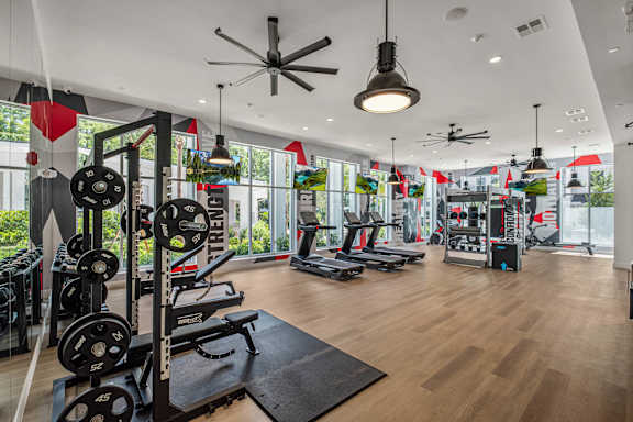 A gym with a variety of equipment including weights and cardio machines.at Altis Grand Twin Lakes, Kissimmee Florida