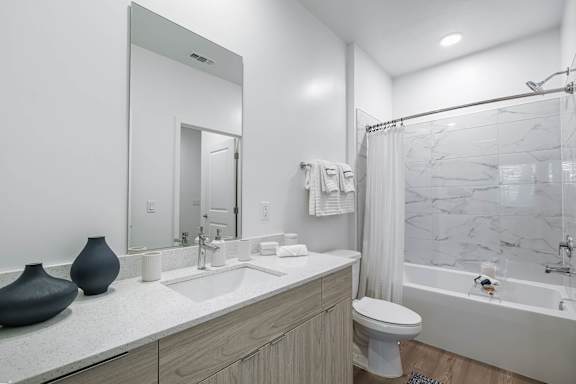 A bathroom with a marble shower and a white toilet.