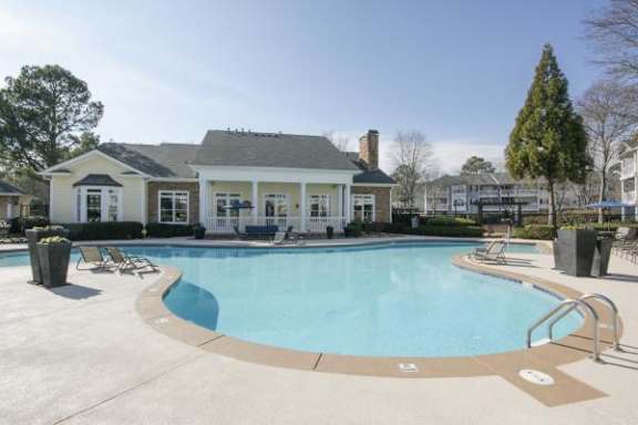 A pool and a house are in the image.
