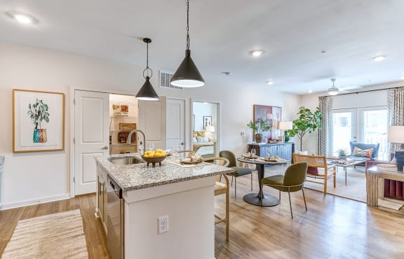 a kitchen and living room with an island and a dining room table