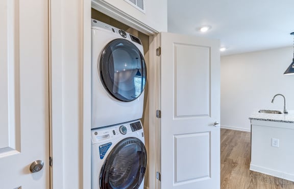 an empty laundry room with a washer and dryer