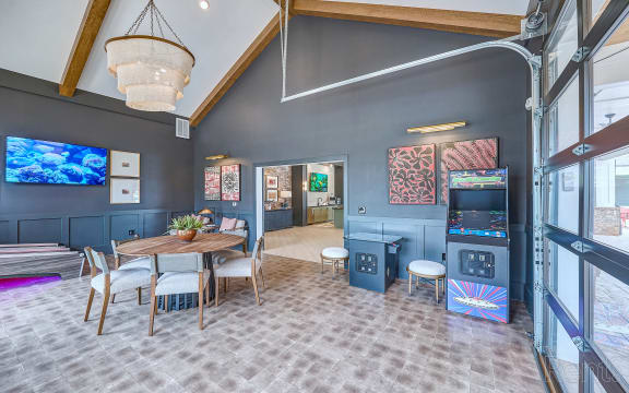 a dining room with a table and chairs and a tv