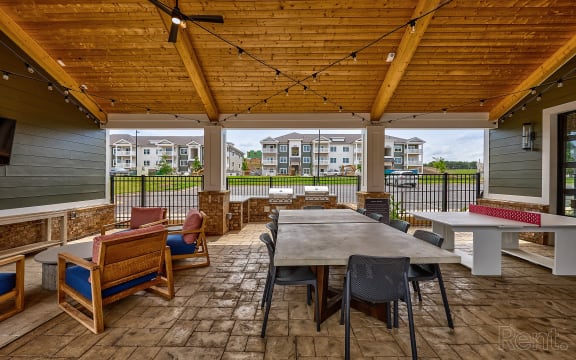 a large patio with a table and chairs