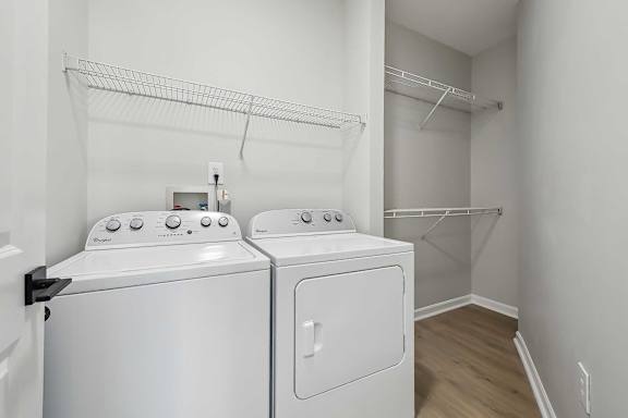 A white washing machine and dryer in a laundry room.
