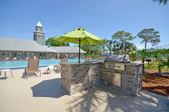 Poolside Sundeck And Grilling Area at Lake in the Woods, Melbourne, FL