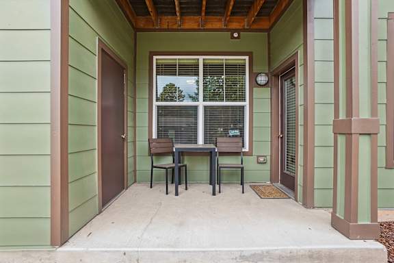 A small patio with a table and chairs.