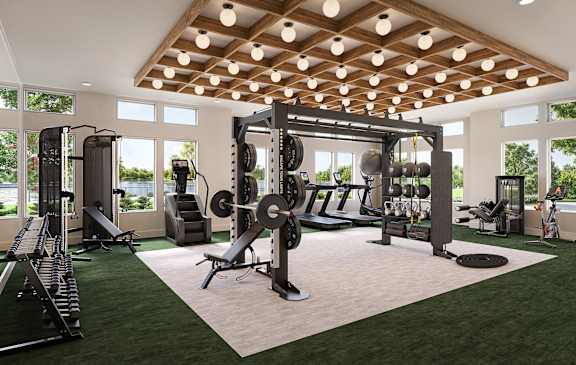 A gym with a variety of equipment including a squat rack, bench, and weights.