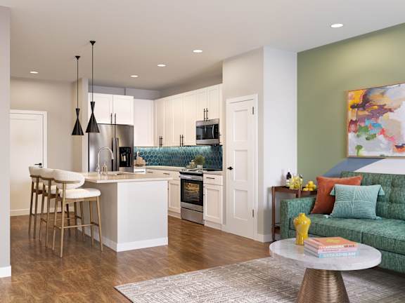 A modern kitchen with a bar area and a green couch.