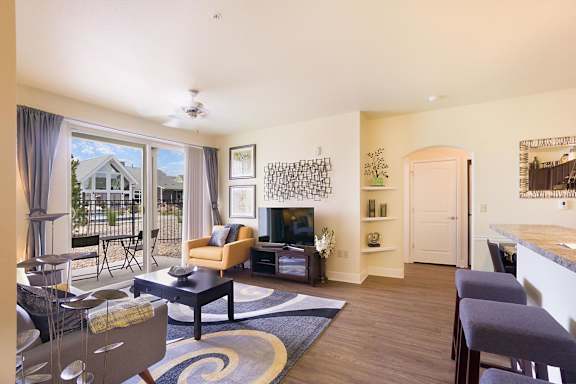 A living room with a fireplace and a dining table.