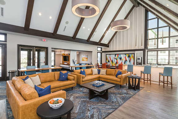A large room with a high ceiling and a long couch.