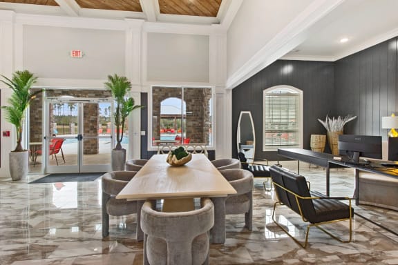 a living room with a table and chairs