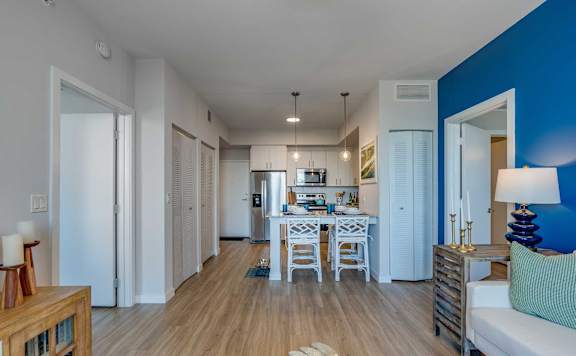 A modern kitchen with a dining table and chairs.