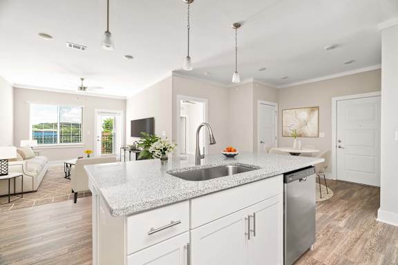 A modern kitchen with a large island and stainless steel appliances.