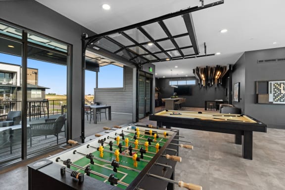 a game room with a foosball table and a pool table