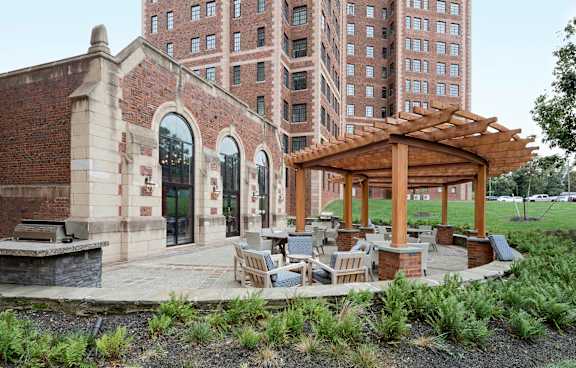 A gazebo sits in the middle of a brick patio.