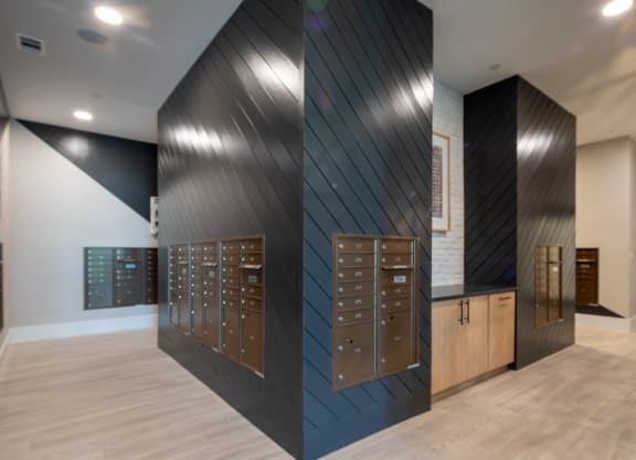 a group of lockers in a room with a wood floor and a black wall