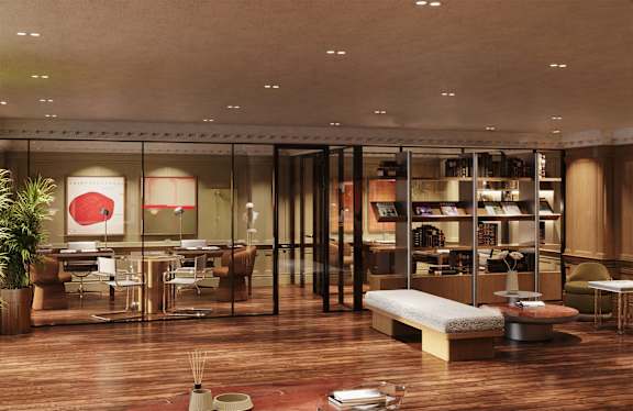 A modern living room with a glass wall and a wooden floor.