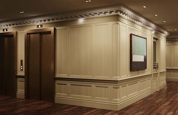 A hallway with wood floors and a white wall with a framed picture.