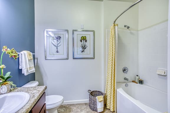 A bathroom with a toilet, sink, and bathtub.