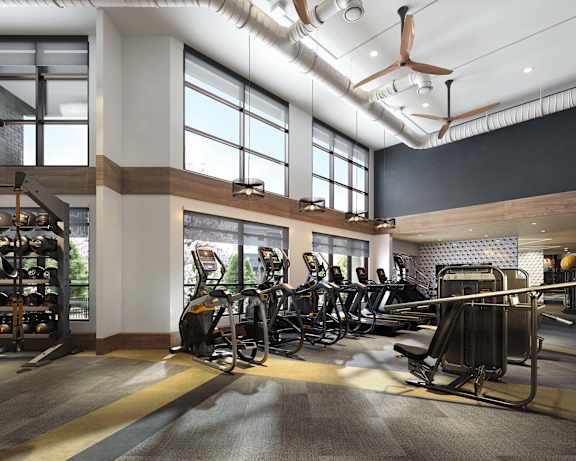 a gym with cardio machines and weights in a lobby