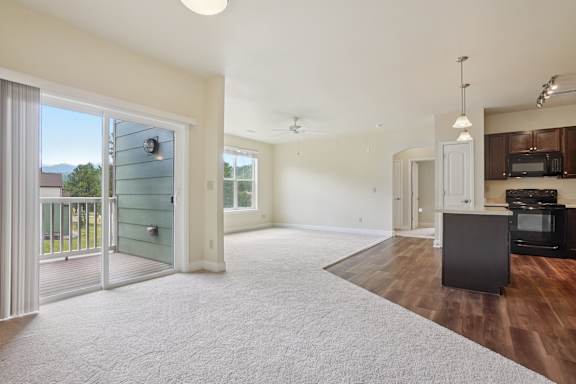 A living room with a television and a sliding glass door.