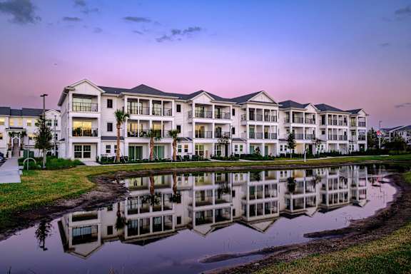 Pond With Building Exterior at Altis Grand Lake Willis, Orlando, FL