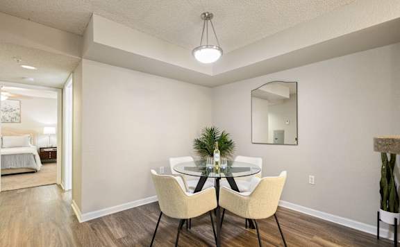 A dining room with a table set for two.