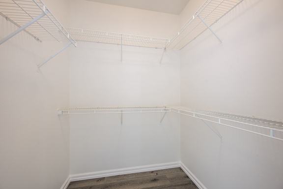 Empty room with white walls and a grey floor.