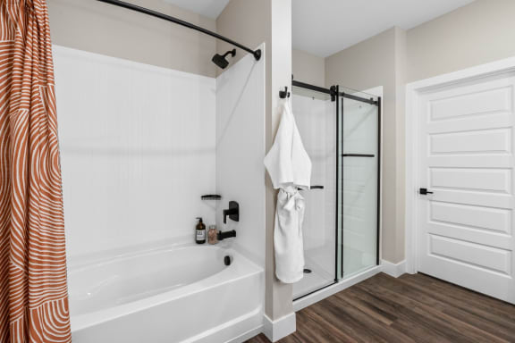 the preserve at ballantyne commons apartment bathroom with tub and shower