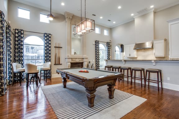 an open living room with a pool table in the middle  at Orion Prosper Lakes, Texas, 75078