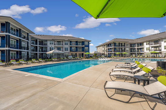 our apartments offer a swimming pool with lounge chairs and umbrellas
