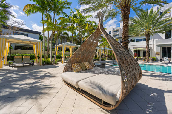 a hanging hammock in a pool area at a resort