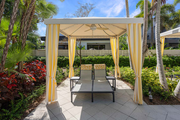 a patio with two chairs and a gazebo