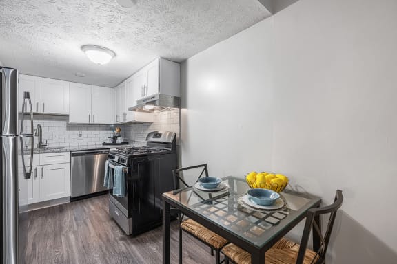 an open kitchen and dining room with a table and chairs