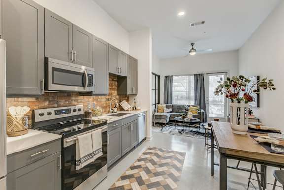 A modern kitchen with a black and white checkered floor.
