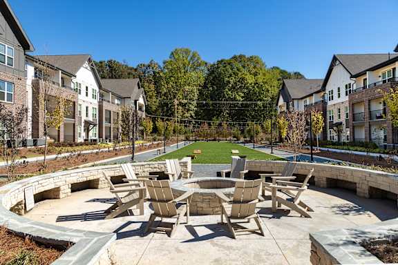A sunny day at a residential complex with a large patio area.